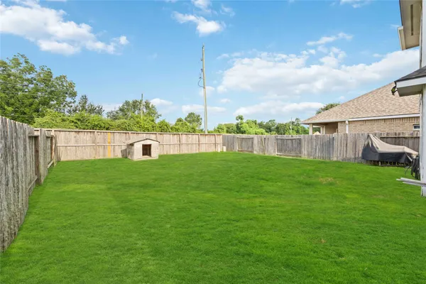 a view of yard with swimming pool and green space