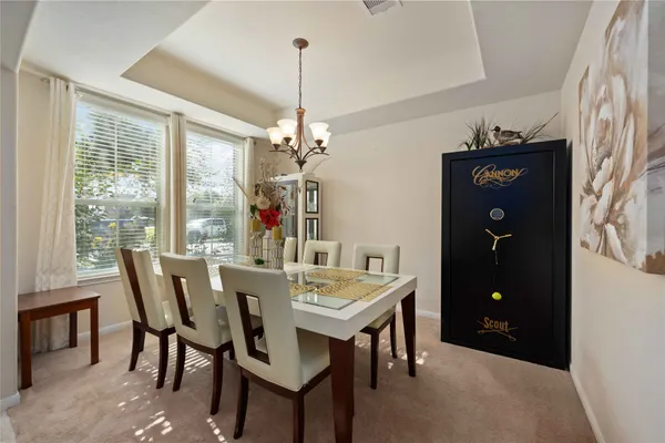 a view of a dining room with furniture window and chandelier