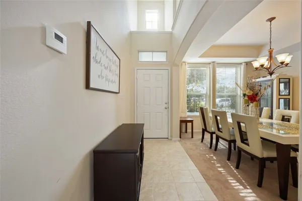 a dining room with furniture and window