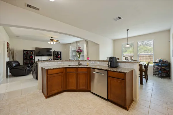 a kitchen with stainless steel appliances granite countertop a sink and cabinets