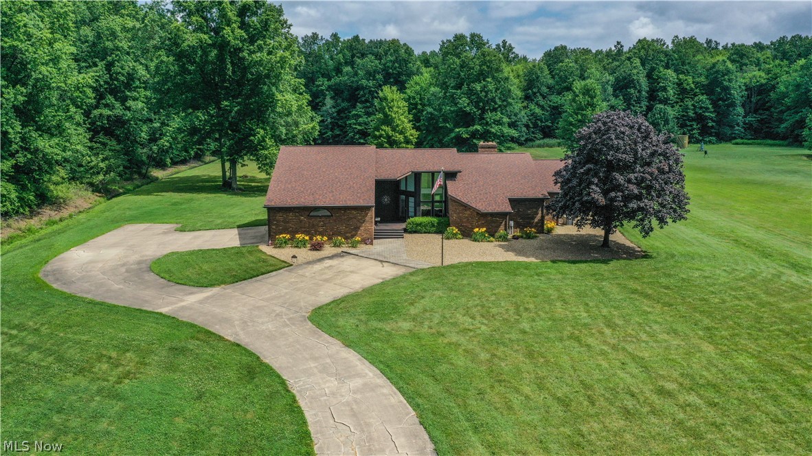 405 Airport Road Northwest Warren, OH 44481 - Photo 46 of 50 Spacious brick ranch home featuring an expansive front lawn, cement driveway, and mature landscaping