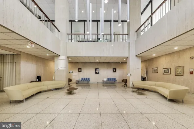 a lobby with furniture and a potted plant