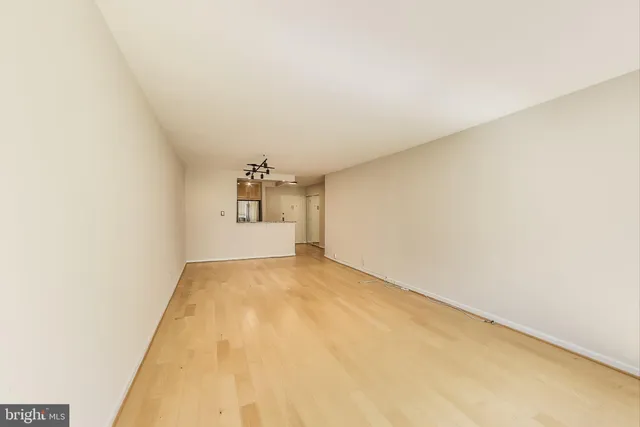 a kitchen with granite countertop a refrigerator and a sink
