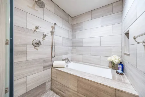 a bathroom with a bathtub and shower