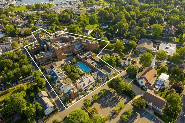 an aerial view of multiple houses with yard