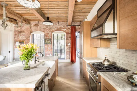a dining room with furniture and wooden floor