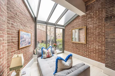 a living room with furniture and a floor to ceiling window