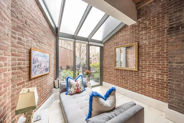 a living room with furniture and a floor to ceiling window