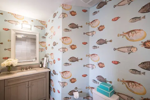 a bathroom with a sink a mirror and shower curtain