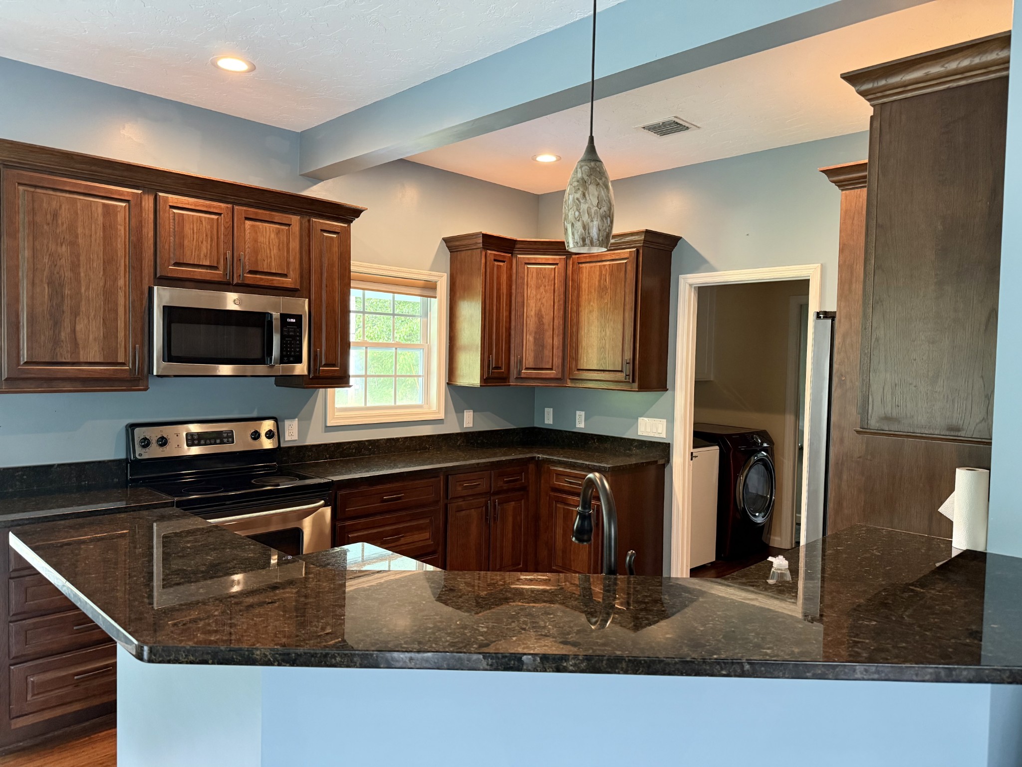 581 Shady Grove Road Bloomington Springs, TN 38545 - Photo 26 of 42 a kitchen with stainless steel appliances granite countertop a sink stove and refrigerator