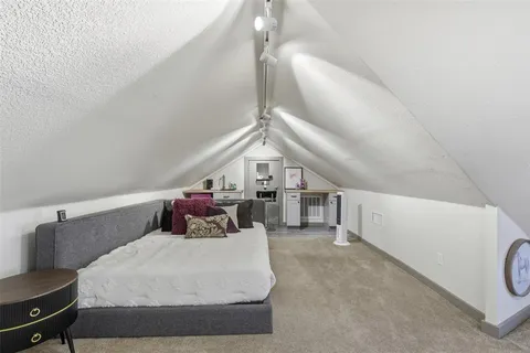 a bed room with a bed and a chandelier