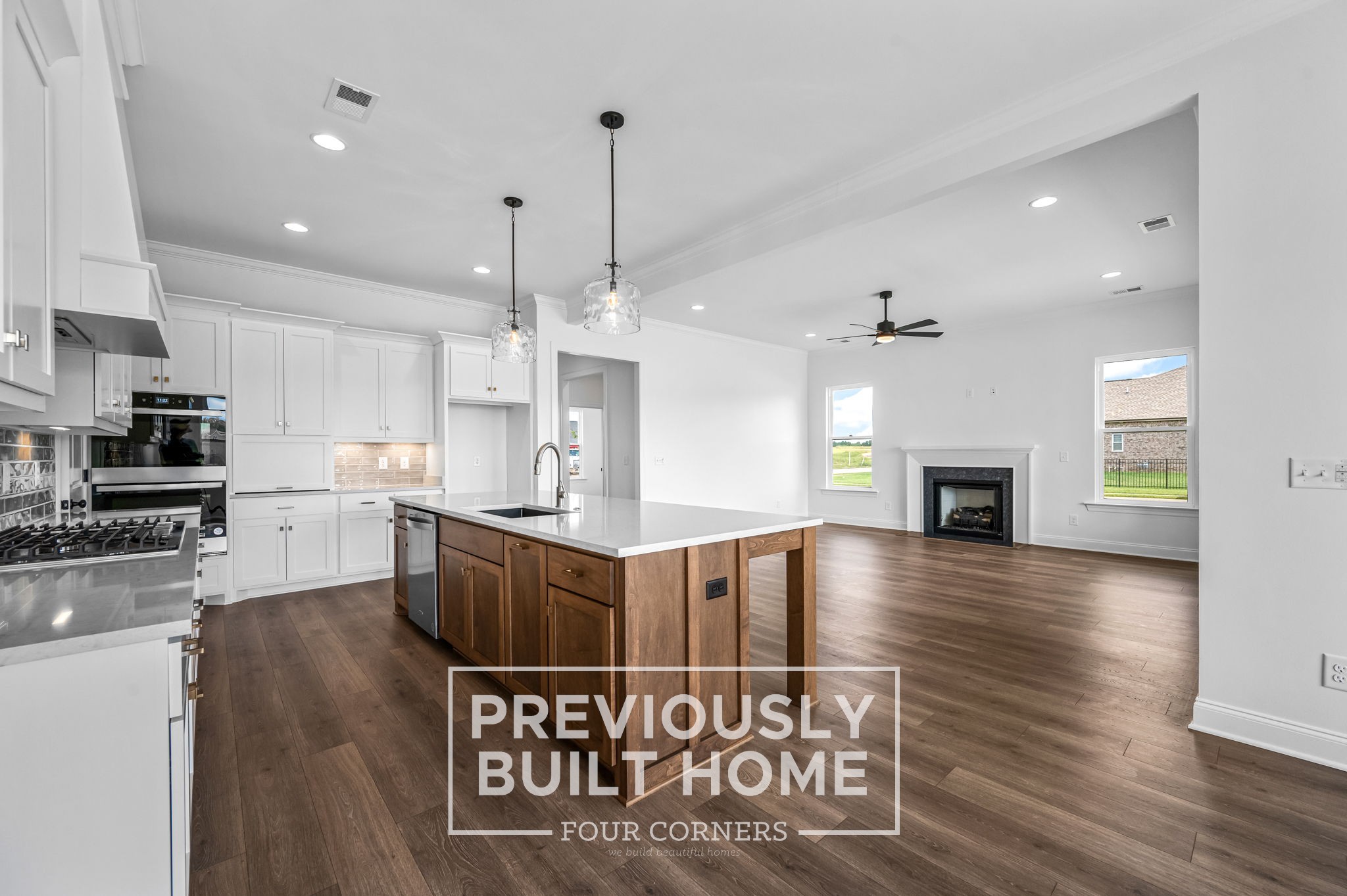 4209 McCown Way Murfreesboro, TN 37127 - Photo 11 of 34 a large kitchen with stainless steel appliances kitchen island granite countertop a stove a sink dishwasher a microwave oven and a dining table with wooden floor
