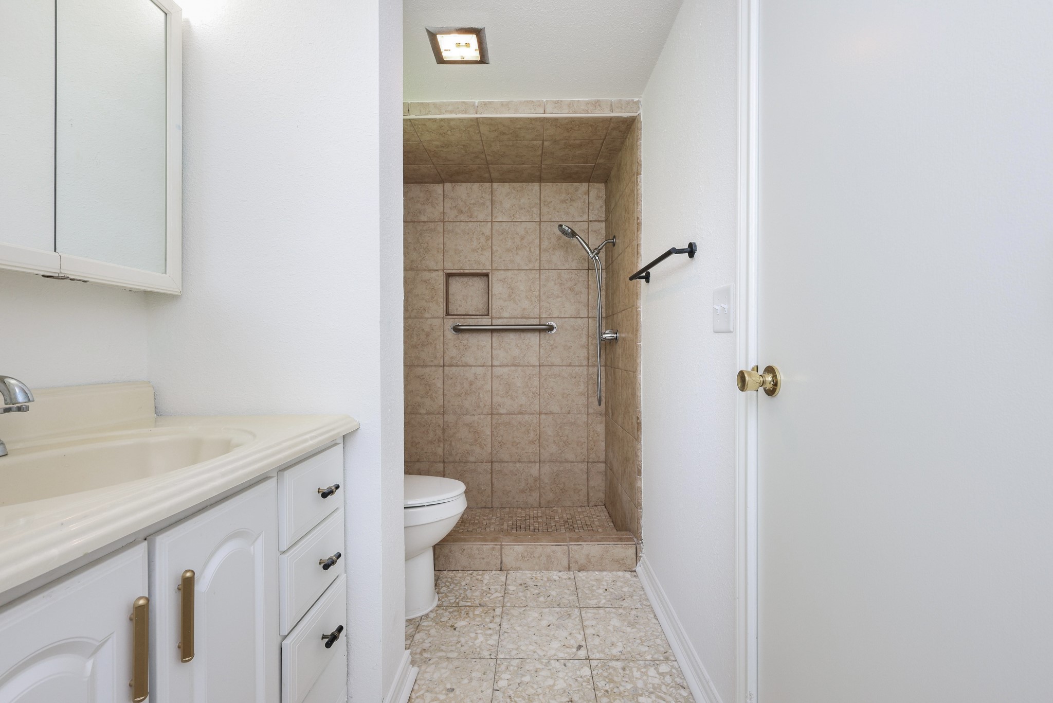 4823 Connorvale Road Houston, TX 77039 - Photo 15 of 26 This primary bathroom features a tiled walk-in shower, a single vanity with storage.