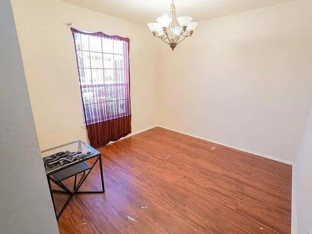 a view of a livingroom with wooden floor and a ceiling fan