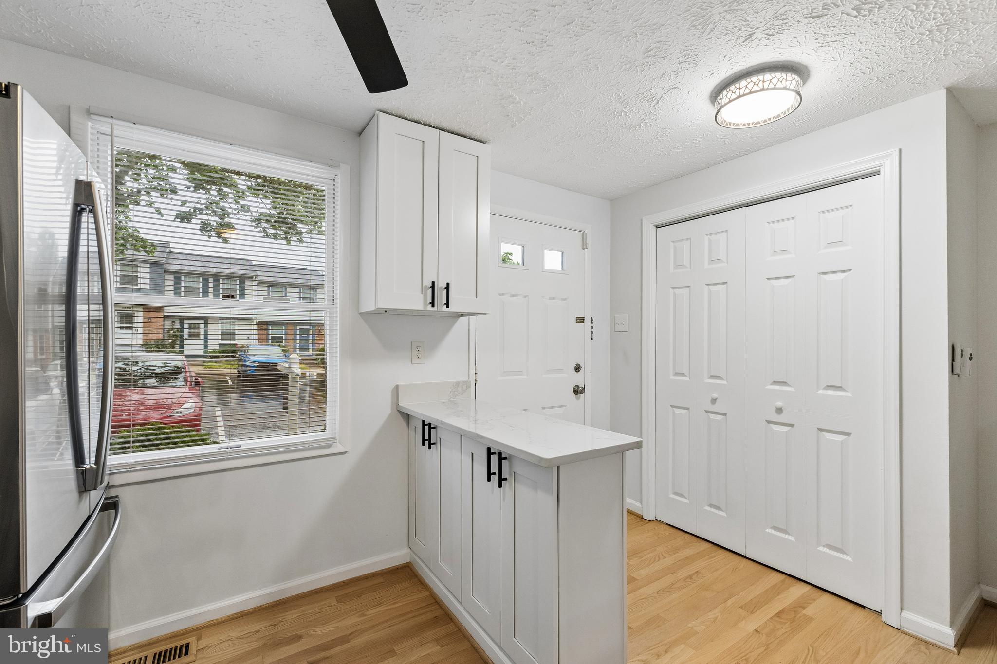 8317 Brookvale Court Springfield, VA 22153 - Photo 2 of 33 a view of hallway with window and wooden floor