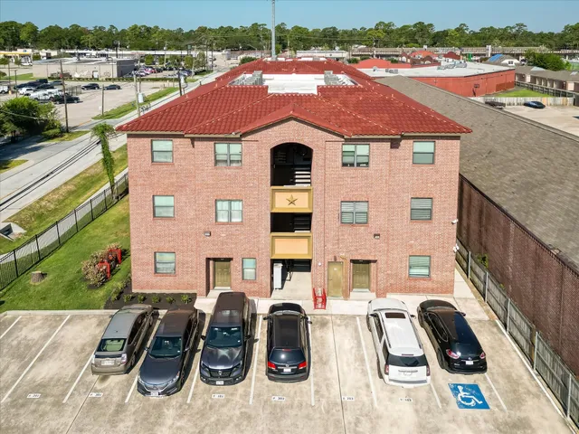 an aerial view of a house with garden space and parking