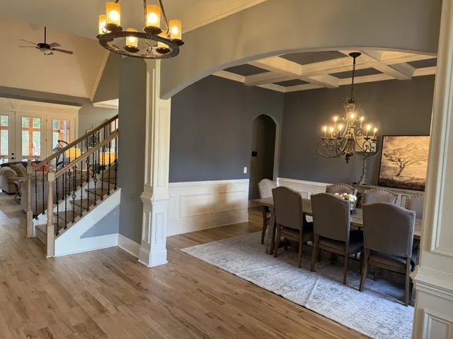 a living room with furniture and a floor to ceiling window
