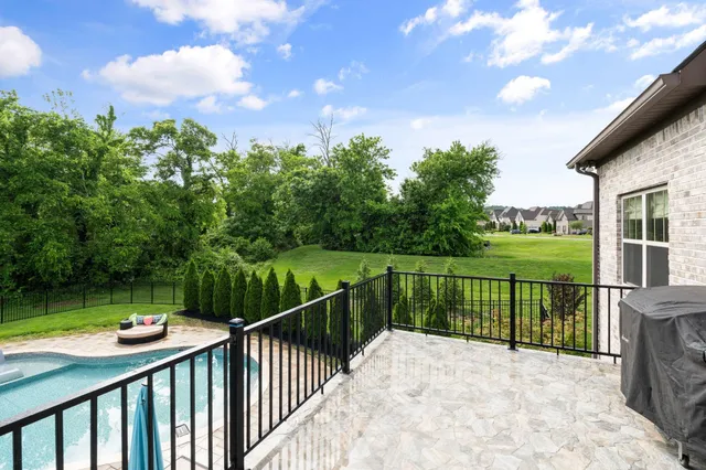 a view of a hallway with entryway and stairs
