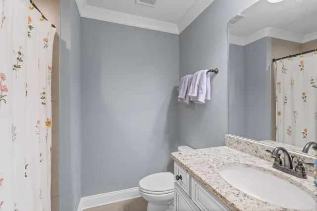 an aerial view of a house with a garden and lake view