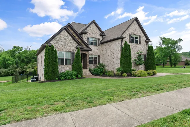 a view of a dining room with furniture a chandelier and wooden floor