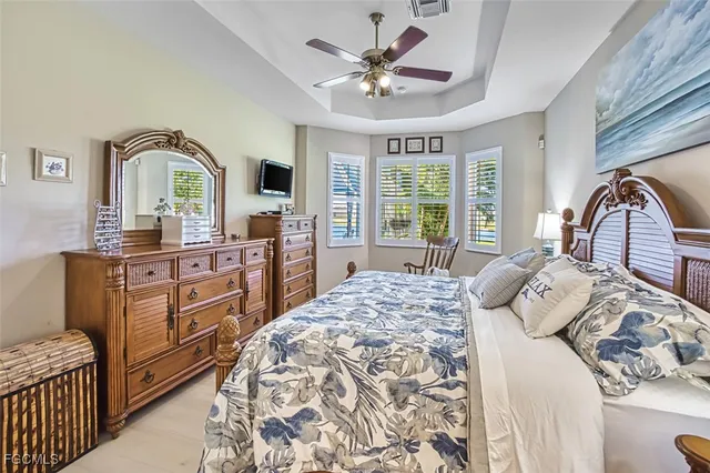 a spacious bedroom with a bed and a chandelier