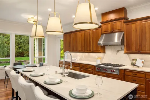 a kitchen with a table chairs stove and cabinets