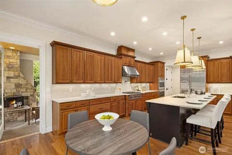 a kitchen with a sink dining table and chairs