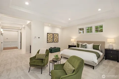 a spacious bedroom with a bed and a couch