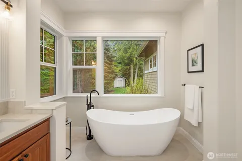 a white bath tub sitting next to a window