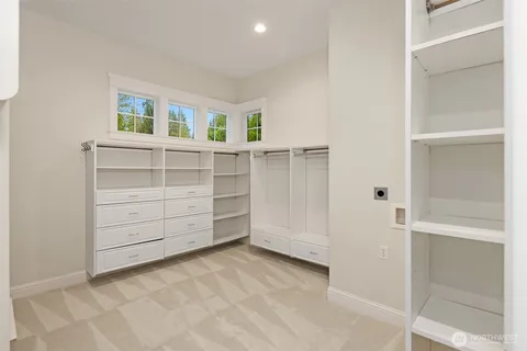 a view of walk in closet with empty racks