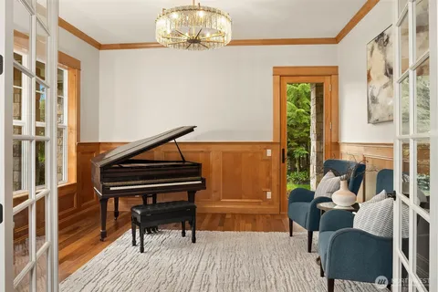 a living room with furniture and a chandelier