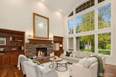 a living room with furniture a fireplace and a large window