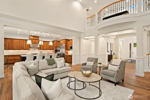 a living room with furniture kitchen view and a table