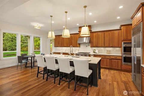 a large kitchen with a table and chairs