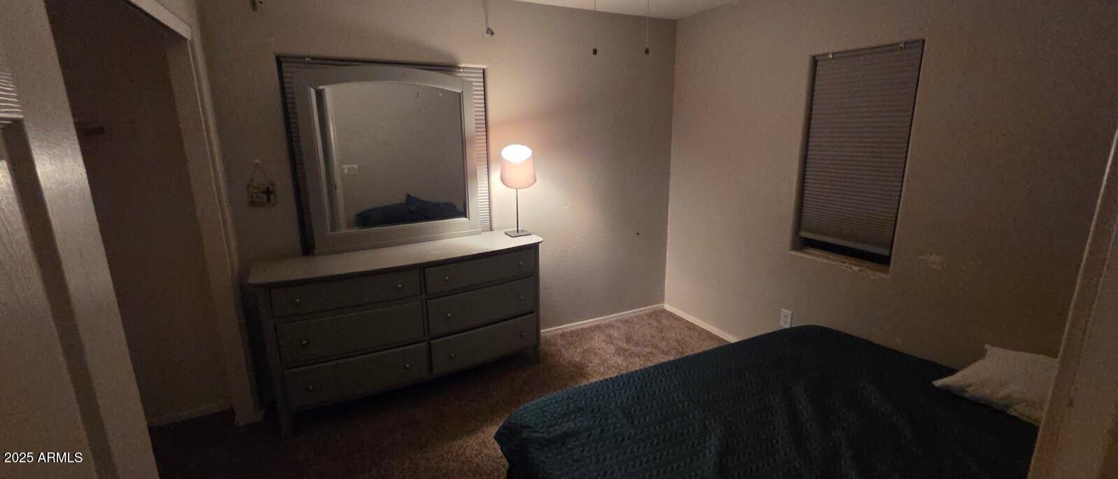 4717 East Redfield Road Gilbert, AZ 85234 - Photo 10 of 13 a bedroom with a bed and a mirror