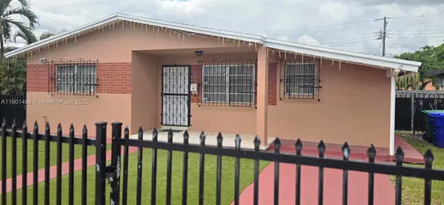 a view of a house with wooden fence