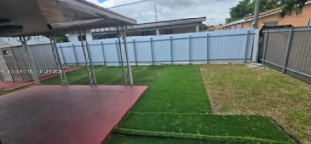 a view of a backyard with fence