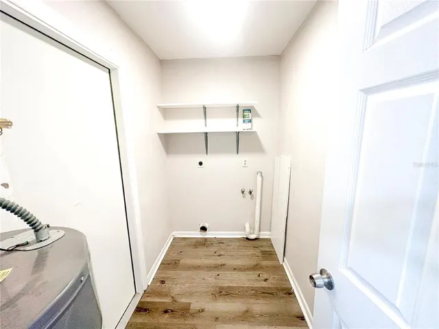 a view of a room with wooden floor and staircase