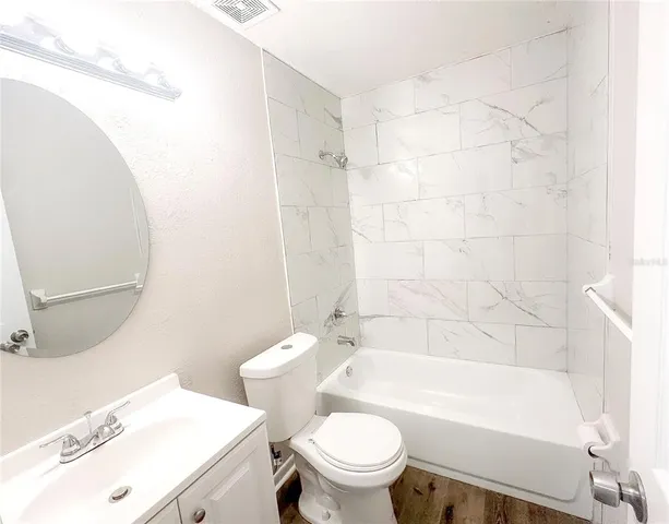 a bathroom with a sink a toilet and a bathtub