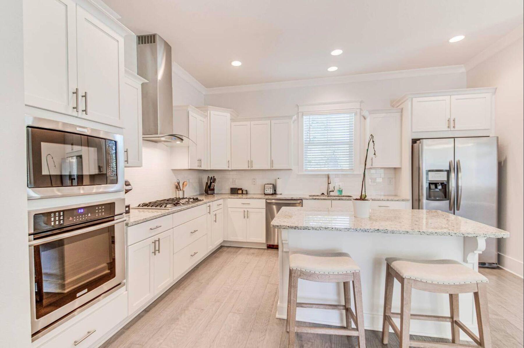318 Grande Pointe Circle Inlet Beach, FL 32461 - Photo 3 of 30 a kitchen with stainless steel appliances granite countertop a stove top oven a sink and white cabinets