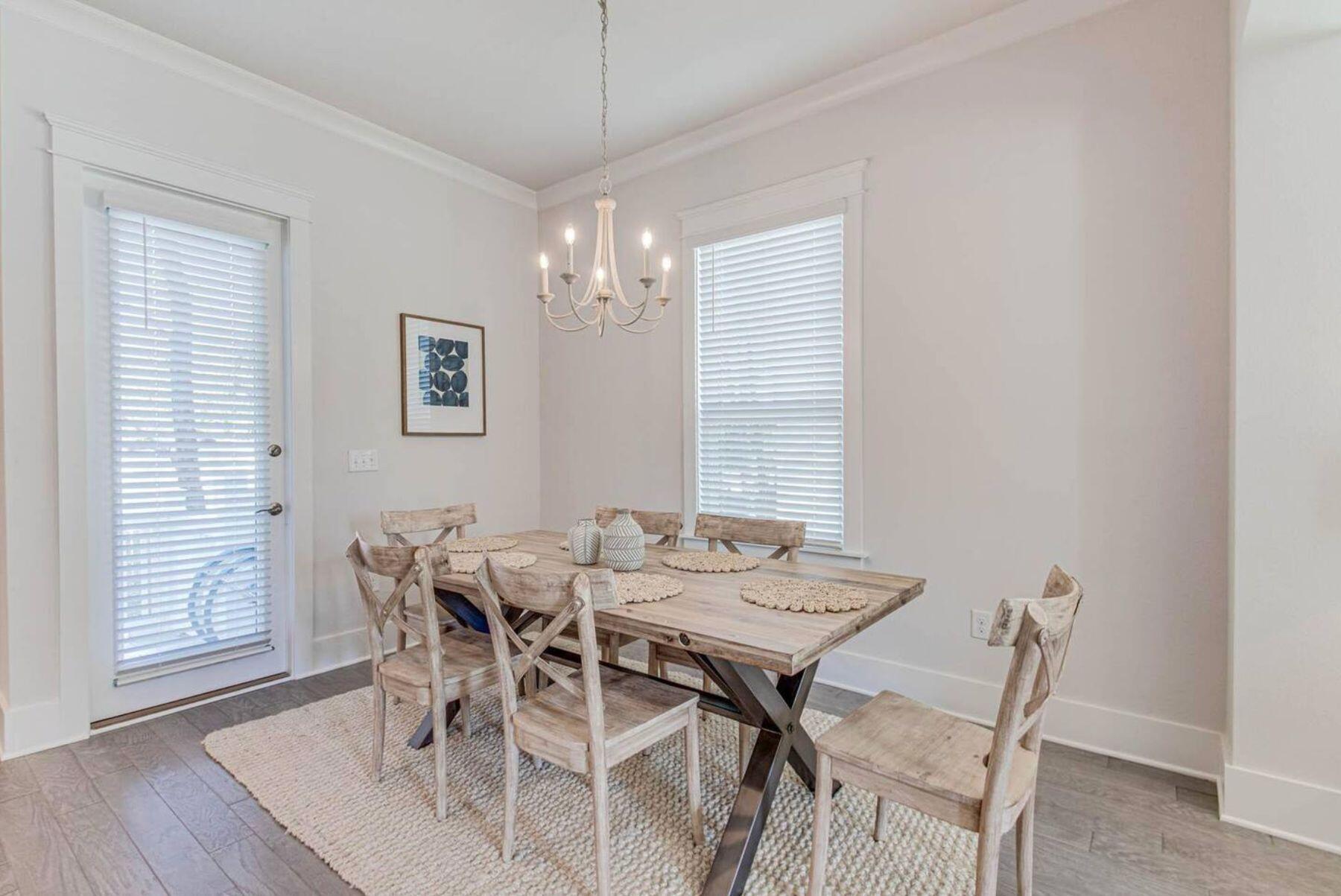 318 Grande Pointe Circle Inlet Beach, FL 32461 - Photo 9 of 30 a view of a dining room with furniture wooden floor and chandelier