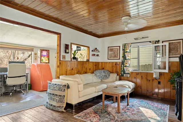 a living room with furniture a rug and a chandelier