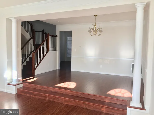 a kitchen with stainless steel appliances granite countertop a refrigerator a stove and a sink with wooden floor