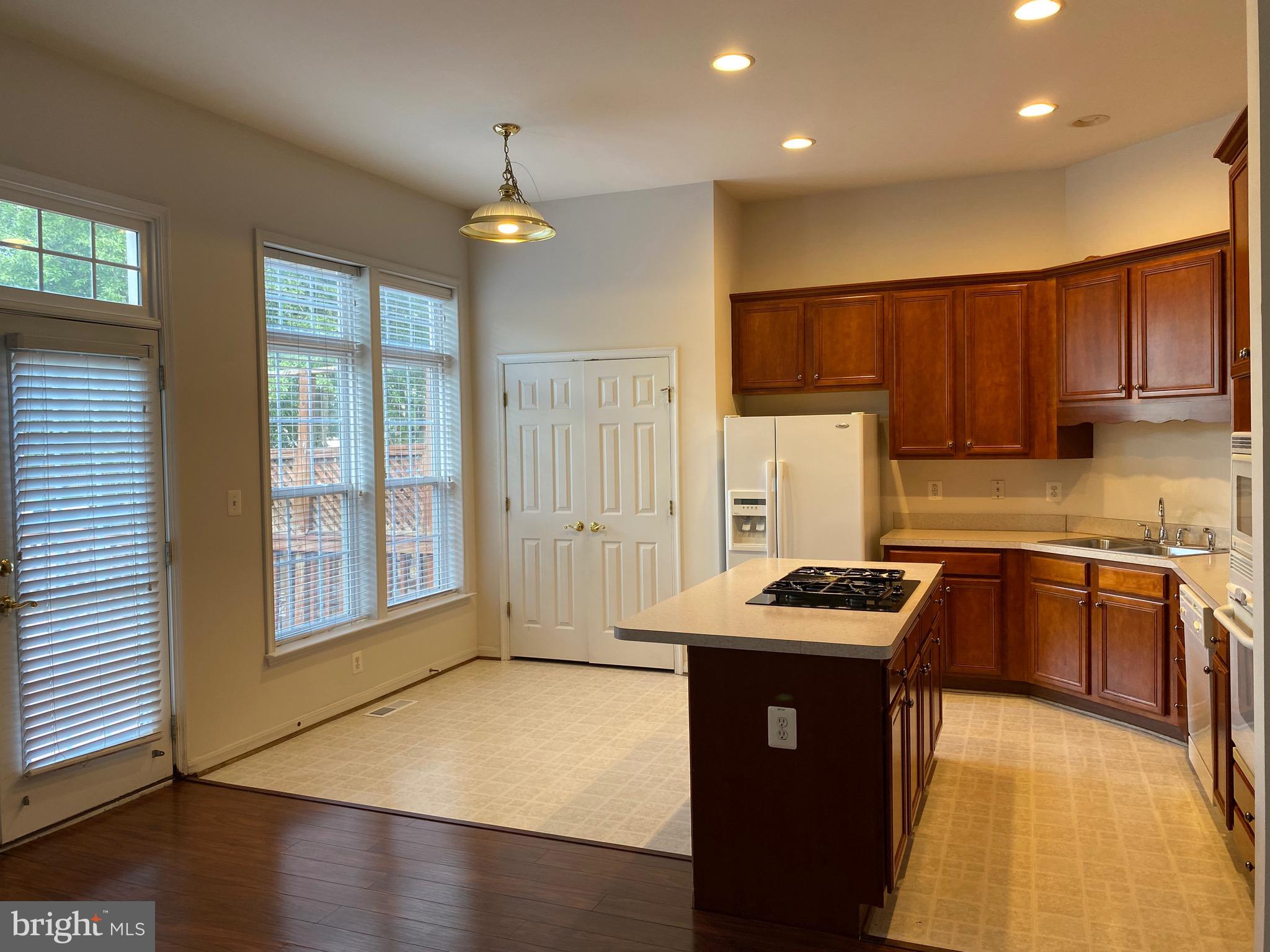 42060 Fremont Preserve Square Aldie, VA 20105 - Photo 29 of 94 a kitchen with stainless steel appliances granite countertop a sink dishwasher a stove and a refrigerator with wooden floor