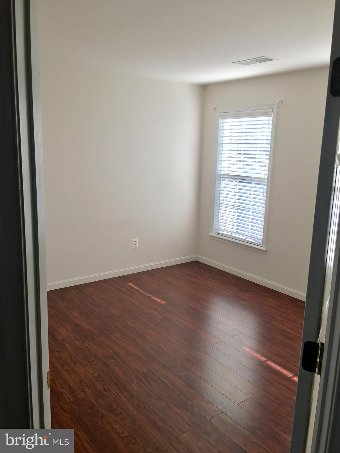 42060 Fremont Preserve Square Aldie, VA 20105 - Photo 44 of 94 an empty room with wooden floor and windows