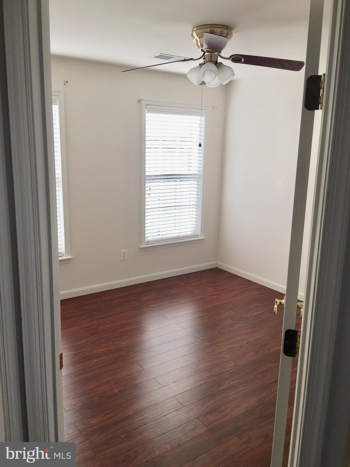 42060 Fremont Preserve Square Aldie, VA 20105 - Photo 46 of 94 an empty room with wooden floor fan and windows