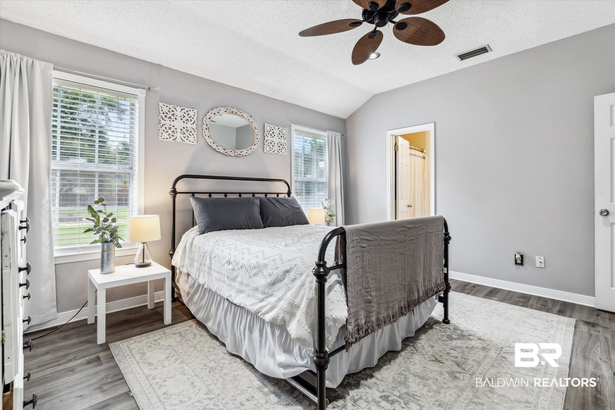 9306 Prairie Drive Semmes, AL 36575 - Photo 9 of 20 Bedroom with vaulted ceiling, light hardwood / wood-style flooring, multiple windows, and ceiling fan