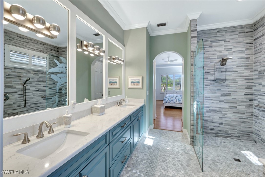 2450 Wulfert Road Sanibel, FL 33957 - Photo 28 of 44 a bathroom with a double vanity sink and a mirror