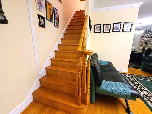a view of a refrigerator in kitchen and an empty room
