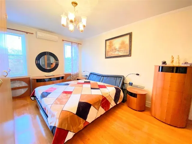 a bedroom with a bed and a chandelier